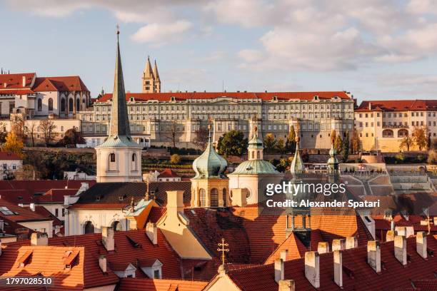 prague cityscape with orange tile rooftops of mala strana, czech republic - mala strana stock-fotos und bilder