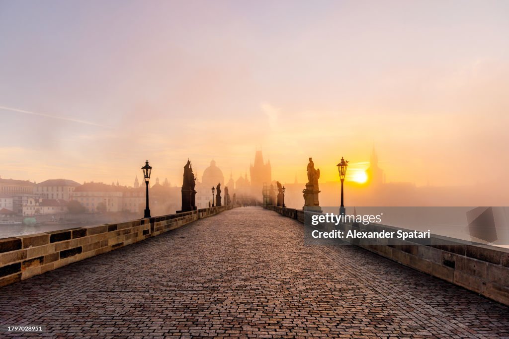 Charles Bridge and Prague old town skyline at sunrise in autumn, Czech Republic