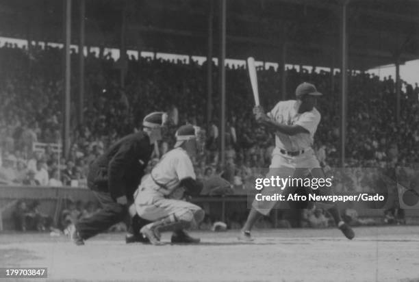 American baseball player Jackie Robinson of the Brooklyn Dodgers takes a cut at a ball during the Dodgers' game where the Bums beat the Tulsa Oilers...