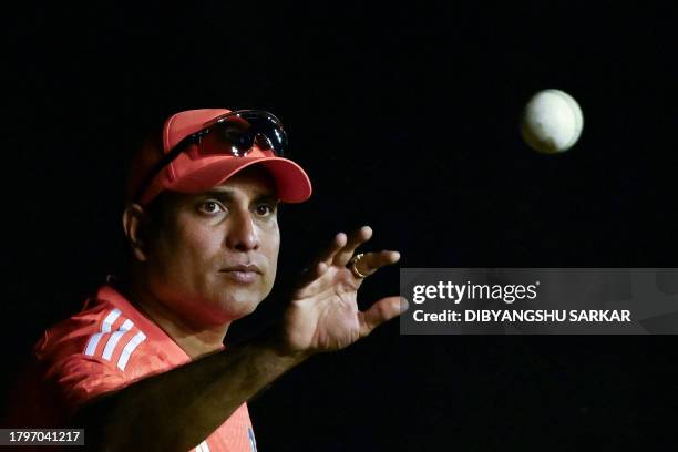 India's coach VVS Laxman collects a ball during a practice session at the Y.S. Rajasekhara Reddy Cricket Stadium in Visakhapatnam on November 22 on...