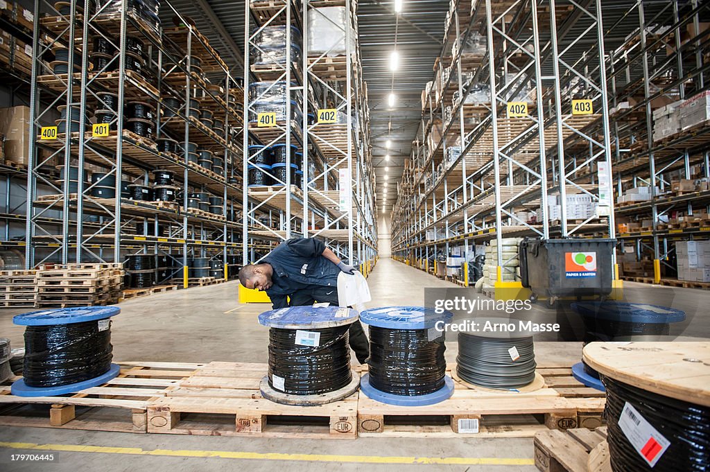 Male warehouse worker checking pallet order
