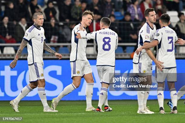 Scott McTominay of Scotland celebrates with teammates after scoring the team's first goal during the UEFA EURO 2024 European qualifier match between...