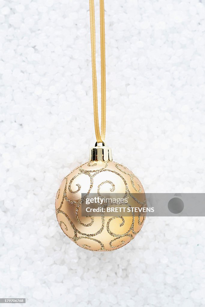 Beige bauble with gold swirls