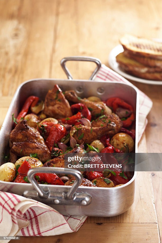 Roast chicken and vegetables in roasting tin