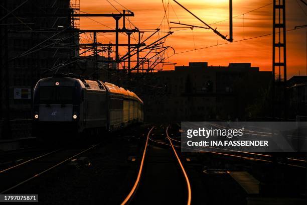 Intercity iC train arrives at the main railway station in Berlin on November 22 as the sun sets over the German capital.