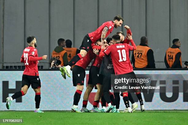 Khvicha Kvaratskhelia of Georgia celebrates with teammates after scoring the team's second goal during the UEFA EURO 2024 European qualifier match...