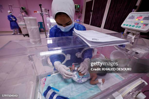 An Egyptian medic provides care to a premature Palestinian baby, recently evacuated from the Gaza Strip, at a hospital in al-Arish in the North Sinai...