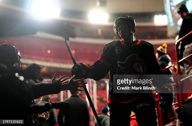 Vladimir Tarasenko of the Ottawa Senators high fives fans on his way back to the locker room after warm-up before the 2023 NHL Global Series in...