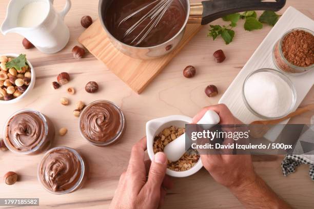 cropped hands of man holding coffee cup by food on table - ashwagandha stockfoto's en -beelden