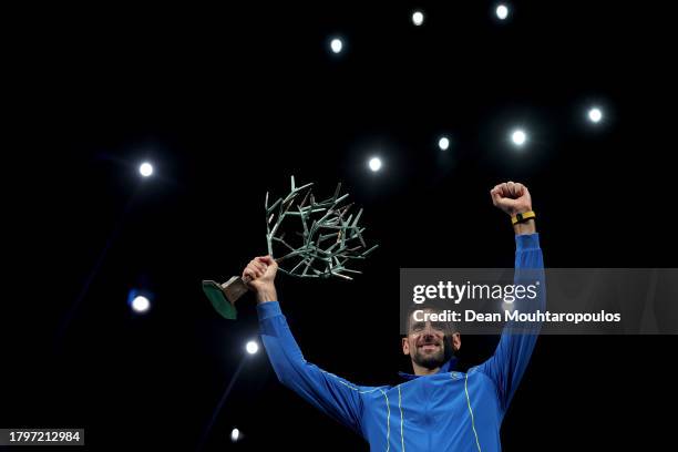 Winner Novak Djokovic of Serbia poses for a photo with the trophy after winning the Men's Singles final against Grigor Dimitrov of Bulgaria on day...