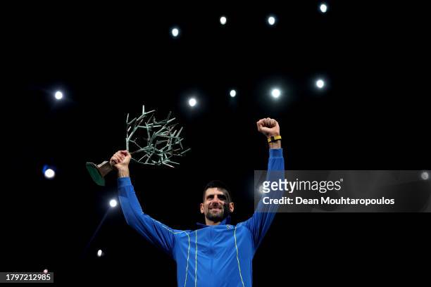 Winner Novak Djokovic of Serbia poses for a photo with the trophy after winning the Men's Singles final against Grigor Dimitrov of Bulgaria on day...