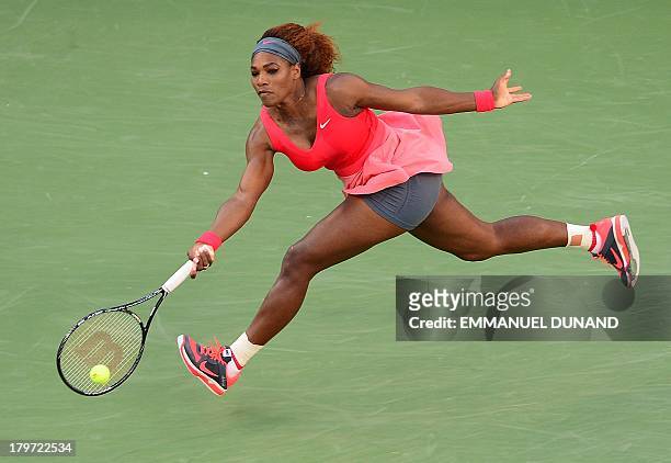 Tennis player Serena Williams plays a shot against China's Li Na during a 2013 US Open women's semifinal match at the USTA Billie Jean King National...
