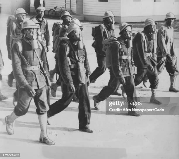 The 6th Battalion marches in gas masks at the Aberdeen Proving Grounds, Aberdeen, Maryland, October 4, 1941.