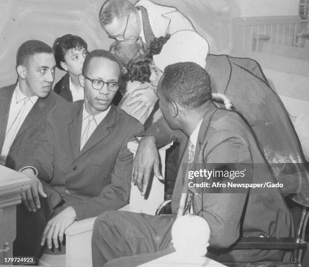 Brief strategy meeting held in the courtroom following the conviction of four out-of-town pickets, Rock Hill, South Carolina, 1961. From left to...