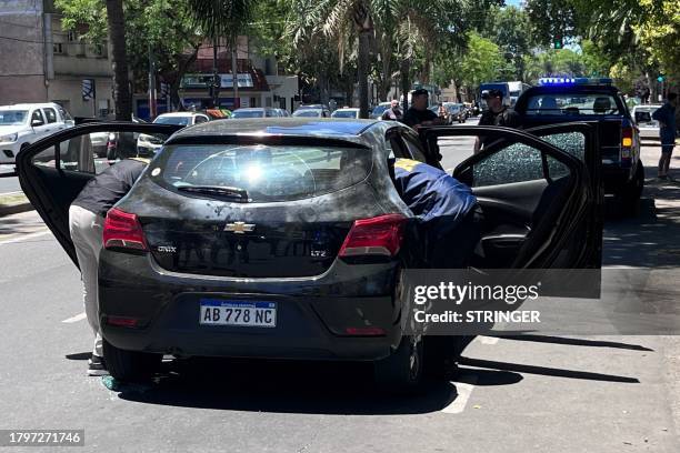 Police officers check the car where Agustina Scaglia, cousin of football star Lionel Messi's wife Antonela Roccuzzo, was transporting money from the...