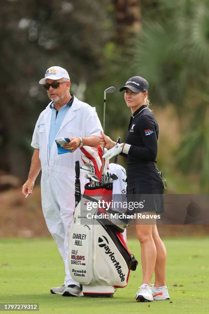 Charley Hull of England and her caddie Adam Woodward wait on the second hole during the first round of the CME Group Tour Championship at Tiburon...