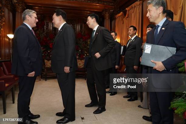 Labour Party leader Sir Keir Starmer talks with the President of South Korea Yoon Suk Yeol as they meet at the Four Seasons Hotel on November 22,...