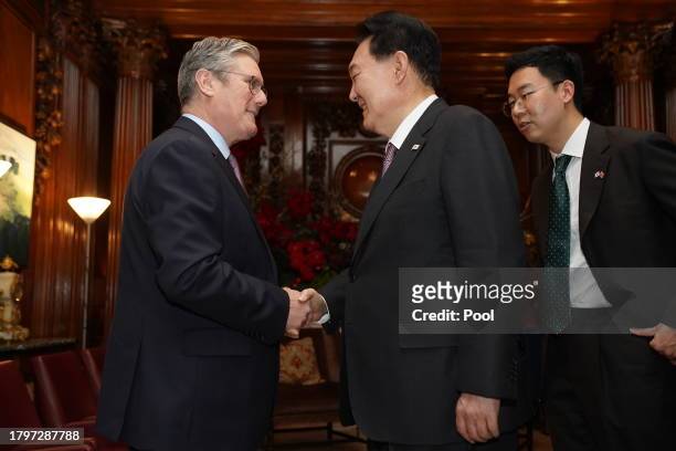Labour Party leader Sir Keir Starmer shakes hands with the President of South Korea Yoon Suk Yeol as they meet at the Four Seasons Hotel on November...
