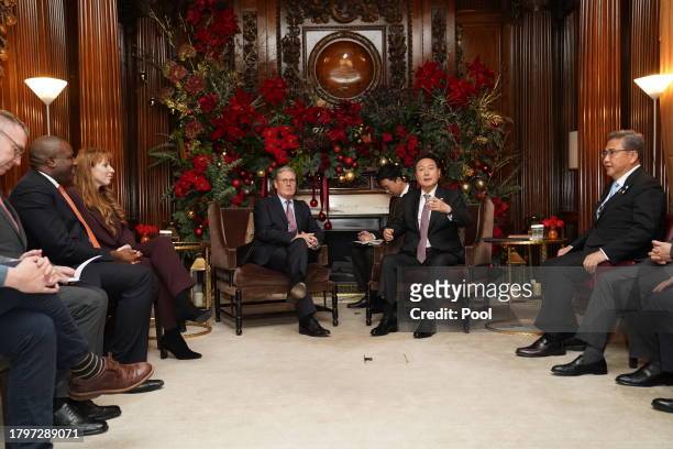 Labour Party leader Sir Keir Starmer sits with the President of South Korea Yoon Suk Yeol as they meet at the Four Seasons Hotel on November 22, 2023...