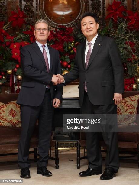 Labour Party leader Sir Keir Starmer shakes hands with the President of South Korea Yoon Suk Yeol as they meet at the Four Seasons Hotel on November...