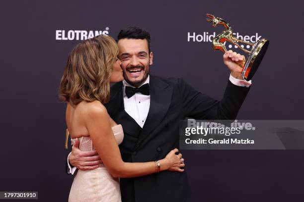 Jana Ina Zarrella and Giovanni Zarrella pose with award trophy during the 75th Bambi Awards at Bavaria Filmstadt on November 16, 2023 in Munich,...