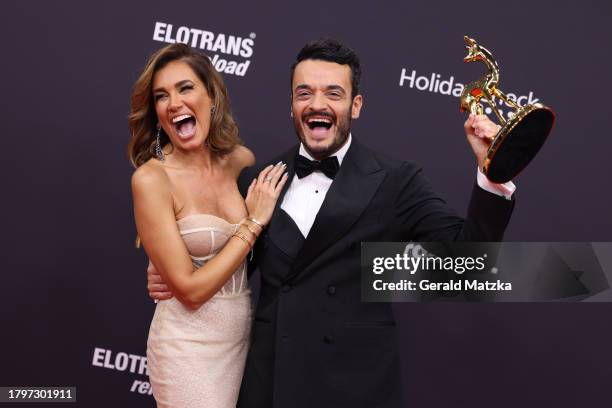 Jana Ina Zarrella and Giovanni Zarrella pose with award trophy during the 75th Bambi Awards at Bavaria Filmstadt on November 16, 2023 in Munich,...