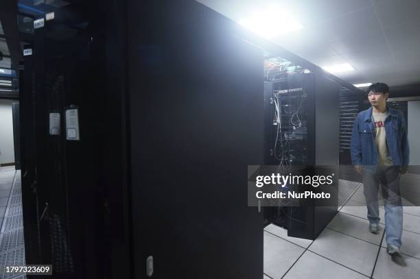 Staff member is checking a supercomputer server in the computer room of Zhejiang University Computing Center in Hangzhou, Zhejiang Province, China,...