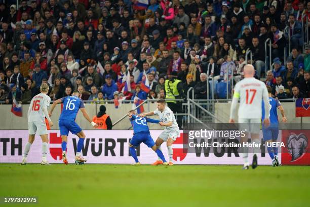 Stanislav Lobotka of Slovakia battles for possession with Johann Gudmundsson of Iceland during the UEFA EURO 2024 European qualifier match between...