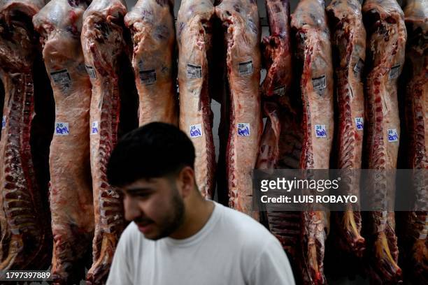An employee works at a butcher shop in Buenos Aires on November 22, 2023.