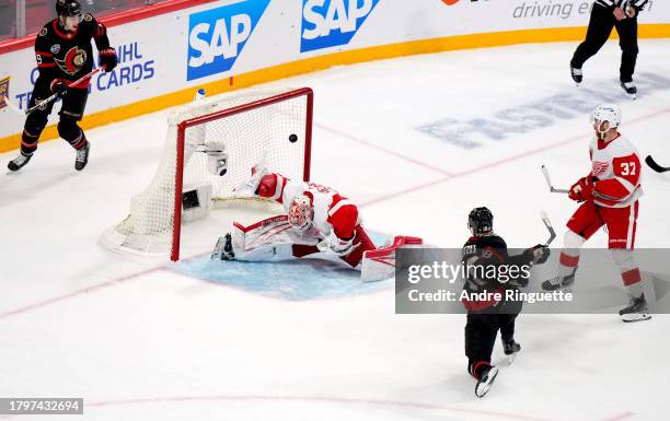 Tim Stutzle of the Ottawa Senators scores against goaltender James Reimer of the Detroit Red Wings in the overtime period of the 2023 NHL Global...