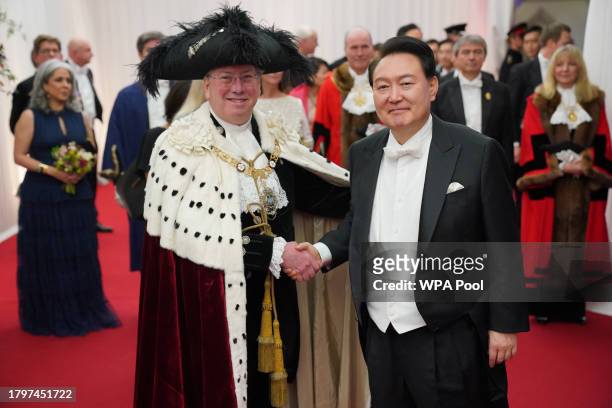 Lord Mayor of the City of London Professor Michael Mainelli welcomes President of South Korea, Yoon Suk Yeol as he arrives to attend a banquet, given...