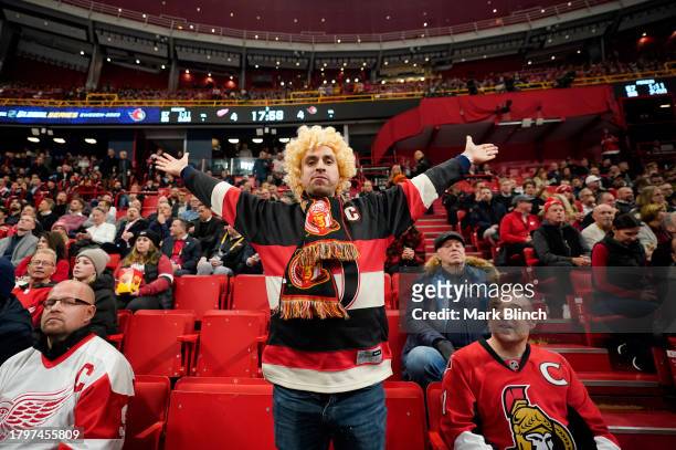 An Ottawa Senators fan stands with open arms during the 2023 NHL Global Series in Sweden between the Detroit Red Wings and the Ottawa Senators at...