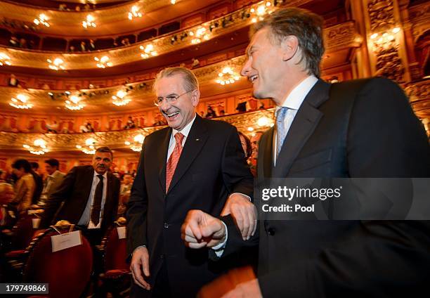 Outgoing International Olympic Committee President Jacques Rogge and Buenos Aires Mayor Mauricio Macri laugh during the opening ceremony of the 125th...