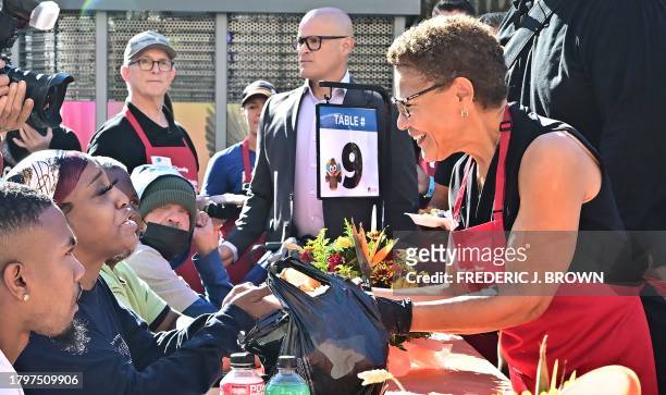 Los Angeles mayor Karen Bass joins volunteers in serving meals during the annual LA Mission Thanksgiving meal on Skid Row in Los Angeles, California...