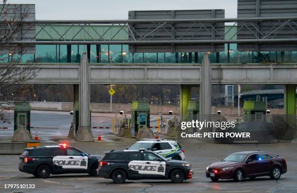 Canadian police cars are seen near the Rainbow Bridge border crossing into the US in Niagara Falls, Ontario, after a car exploded at a US-Canada...