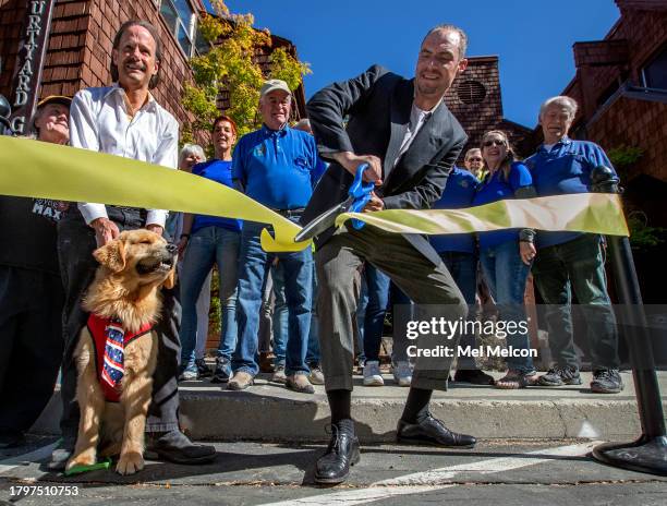 Maximus Mighty Dog Mueller III, also known as Mayor Max III, the mayor of Idyllwild, with owner Glen Warren, looks on as Taylor Brechtel,...