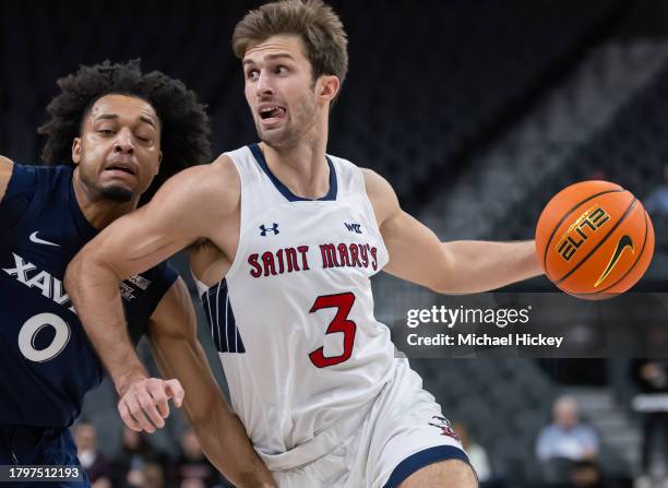 Augustas Marciulionis of the St. Mary's Gaels drives to the basket against Trey Green of the Xavier Musketeers in the Continental Tire Main Event at...