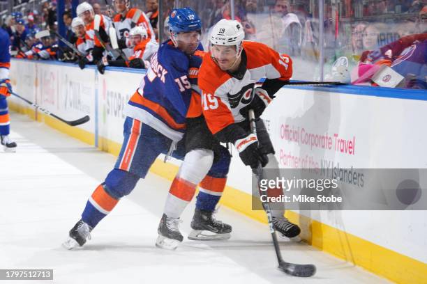 Cal Clutterbuck of the New York Islanders, playing in his 1000th career NHL game checks Garnet Hathaway of the Philadelphia Flyers during the first...