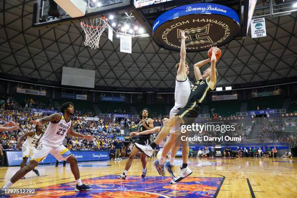 Fletcher Loyer of the Purdue Boilermakers shoots and draws contact and the foul from Ben Gold of the Marquette Golden Eagles during the second half...