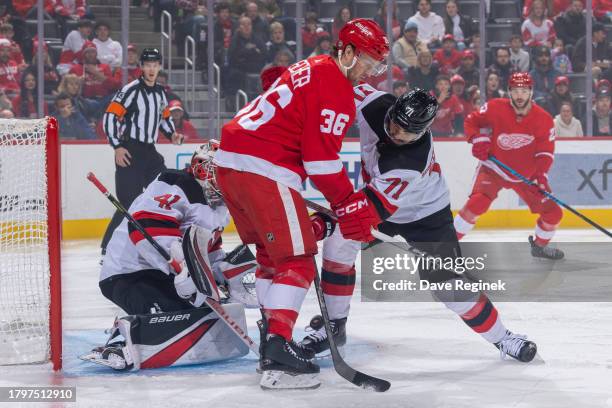 Jonas Siegenthaler of the New Jersey Devils defends against Christian Fischer of the Detroit Red Wings in front of the net during the first period at...