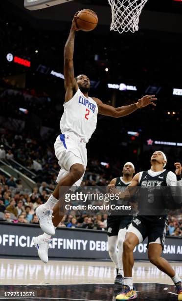 Kawhi Leonard of the Los Angeles Clippers drives past Keldon Johnson of the San Antonio Spurs in the first half at Frost Bank Center on November 22,...