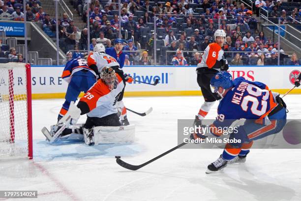 Brock Nelson of the New York Islanders scores a third period goal past Carter Hart of the Philadelphia Flyers at UBS Arena on November 22, 2023 in...