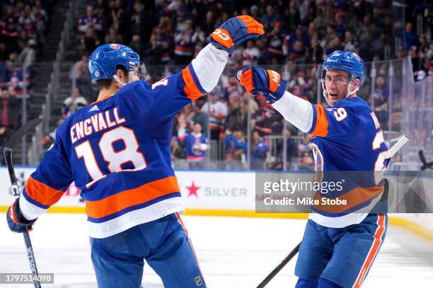 Brock Nelson of the New York Islanders is congratulated by Pierre Engvall after scoring a goal against the Philadelphia Flyers during the third...