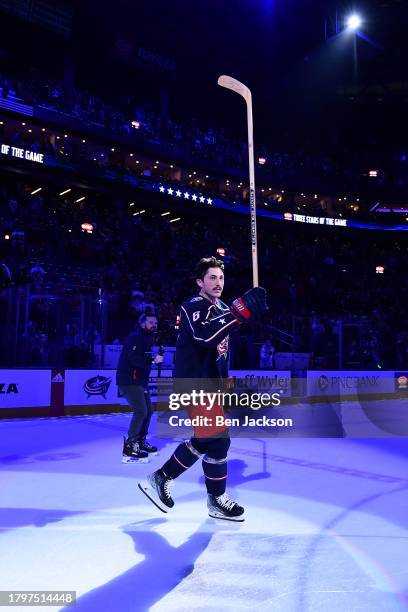 Zach Werenski of the Columbus Blue Jackets salutes the fans after being named first star of the game following a 7-3 victory over the Chicago...