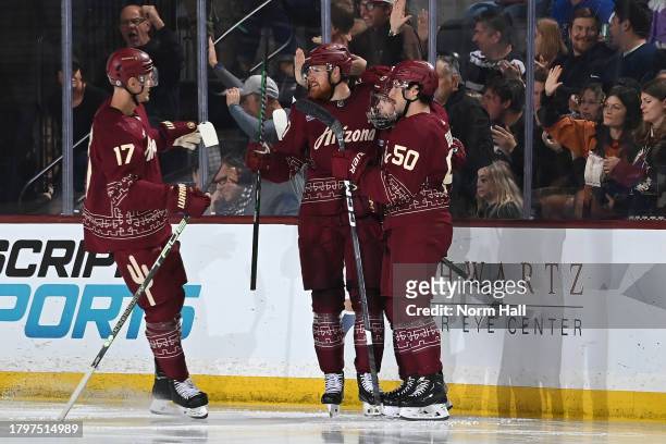 Lawson Crouse of the Arizona Coyotes celebrates with Matias Maccelli, Sean Durzi and teammates after scoring a goal against the St Louis Blues during...