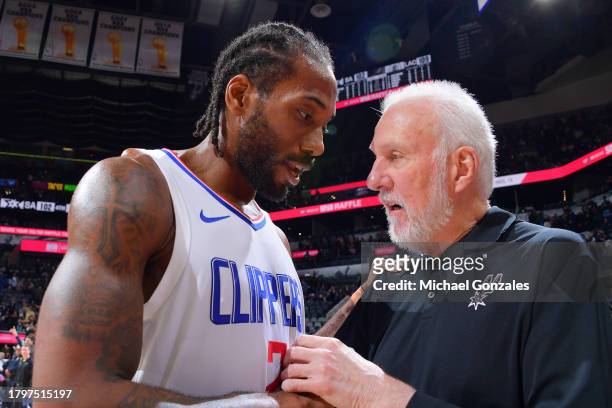 Kawhi Leonard of the LA Clippers talks to Head Coach Gregg Popovich of the San Antonio Spurs after the game on November 22, 2023 at the Frost Bank...