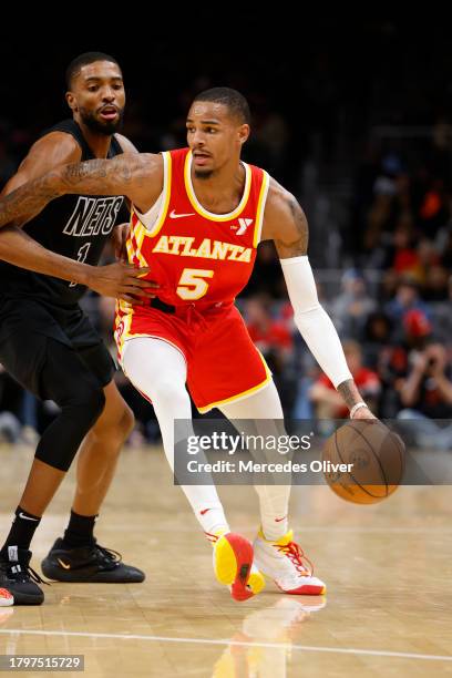 Dejounte Murray of the Atlanta Hawks handles the ball during the game against the Brooklyn Nets on NOVEMBER 22, 2023 at State Farm Arena in Atlanta,...