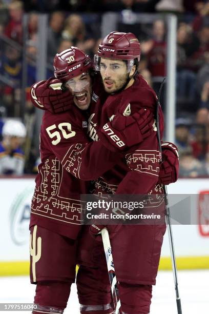 Arizona Coyotes center Nick Schmaltz celebrates after scoring a goal with Arizona Coyotes defenseman Sean Durzi against the St. Louis Blues during...