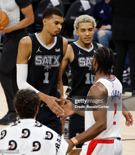 Victor Wembanyama of the San Antonio Spurs is congratulated by Kawhi Leonard of the Los Angeles Clippers at the end of the game at Frost Bank Center...