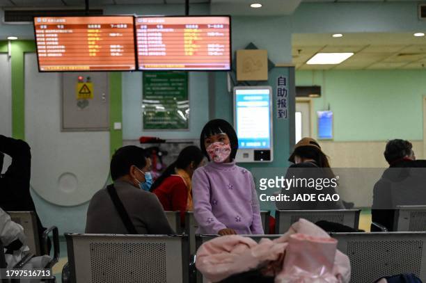 Children and their parents wait at an outpatient area at a children hospital in Beijing on November 23, 2023. The World Health Organization has asked...